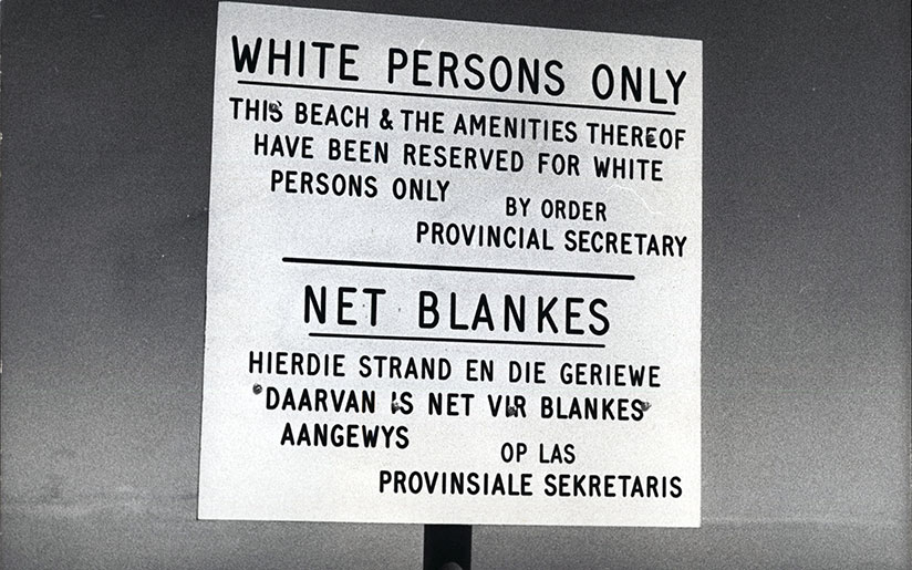 Photo of a sign indicating that the beach is reserved for white people only