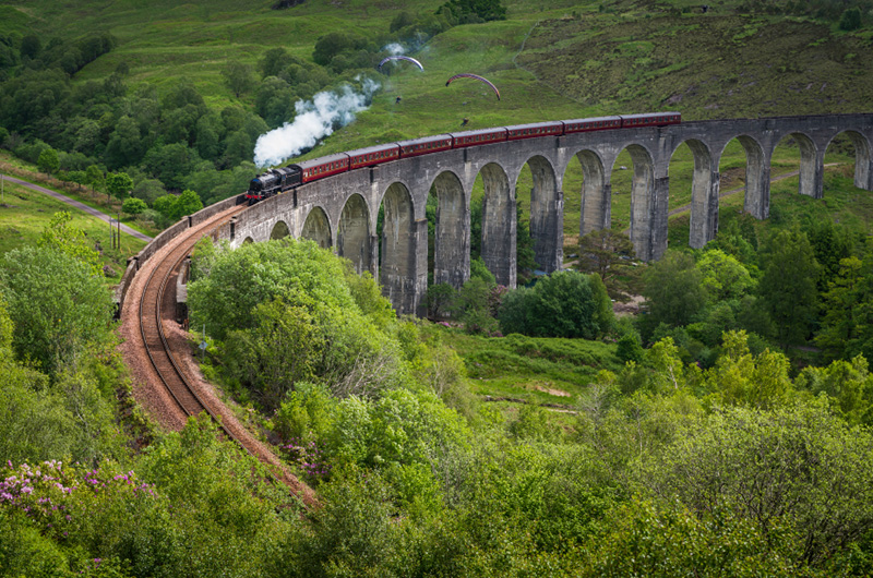 Photo of a stream train crossing a viaduct in the Highlands